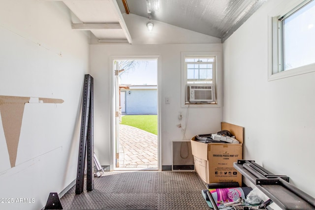 doorway to outside featuring cooling unit, lofted ceiling, and carpet flooring