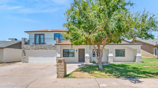 view of front of home with a garage and a front lawn