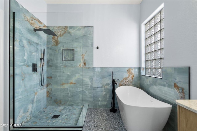 bathroom featuring independent shower and bath and tile walls