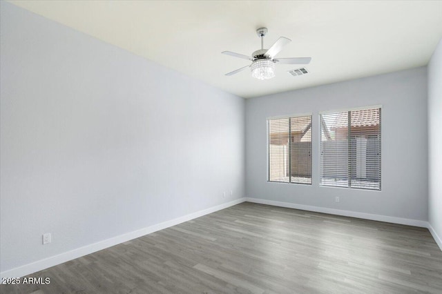 empty room featuring hardwood / wood-style flooring and ceiling fan