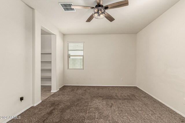 carpeted empty room with ceiling fan