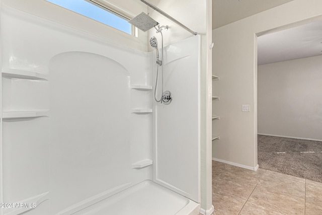 bathroom featuring walk in shower and tile patterned flooring