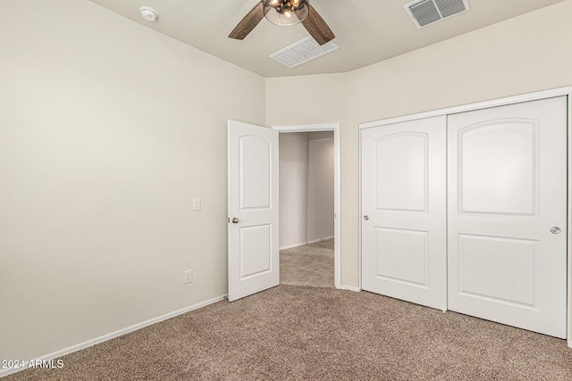 unfurnished bedroom featuring light carpet, a closet, and ceiling fan