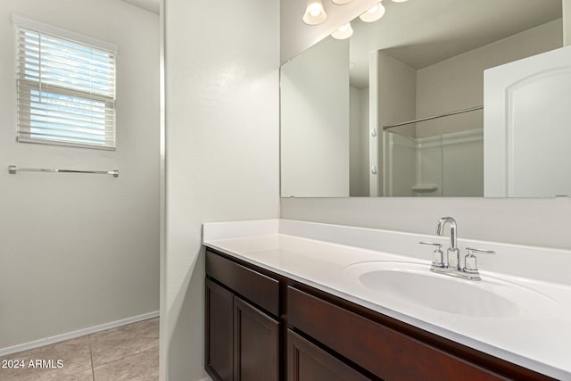 bathroom with vanity, tile patterned floors, and walk in shower