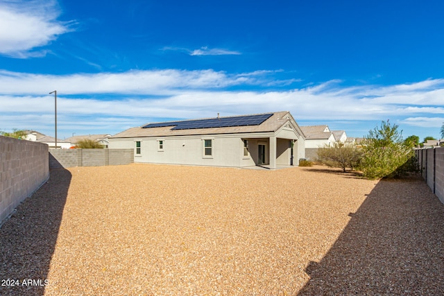 back of house with solar panels