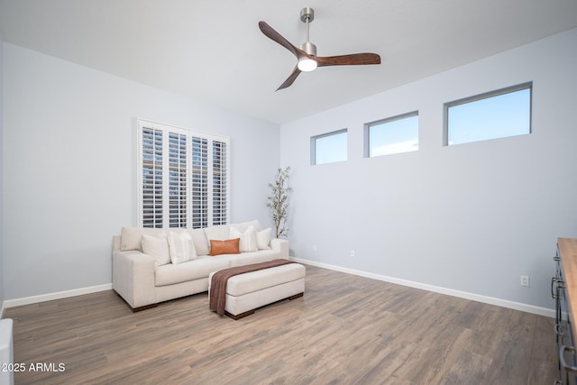 living area with dark hardwood / wood-style floors and ceiling fan