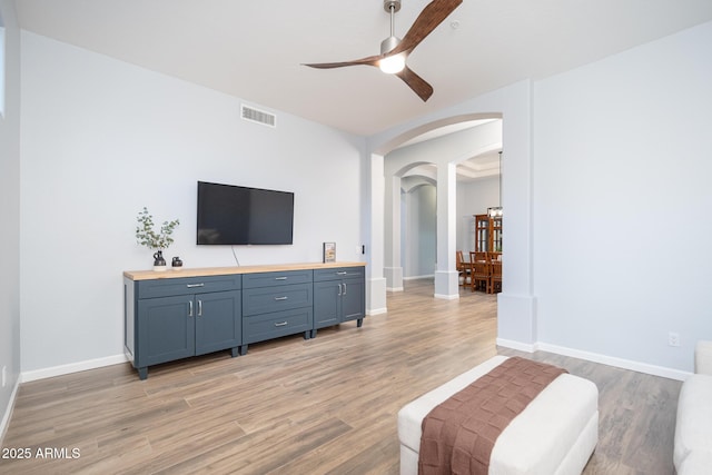 living room featuring hardwood / wood-style floors and ceiling fan