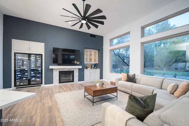 living room with hardwood / wood-style floors, beverage cooler, and ceiling fan