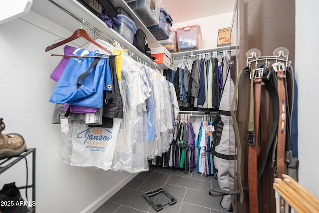 spacious closet with dark tile patterned flooring