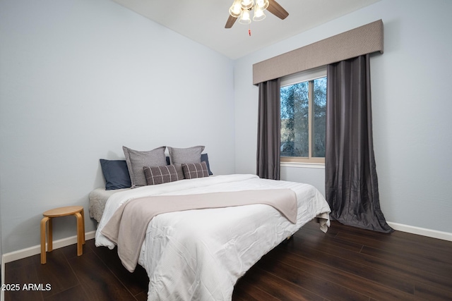 bedroom with dark hardwood / wood-style flooring and ceiling fan