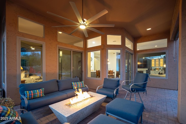 view of patio / terrace with an outdoor living space with a fire pit