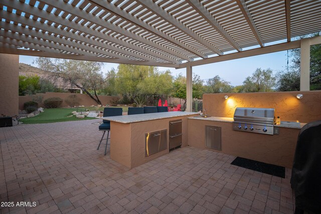 view of patio with a pergola, grilling area, an outdoor bar, and an outdoor kitchen