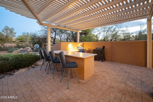 view of patio / terrace with a pergola, area for grilling, and exterior bar