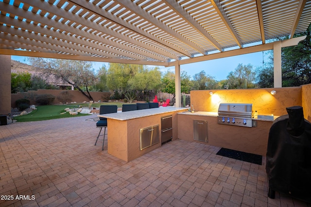 view of patio / terrace featuring exterior bar, a pergola, an outdoor kitchen, and grilling area