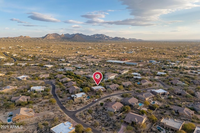 birds eye view of property with a mountain view