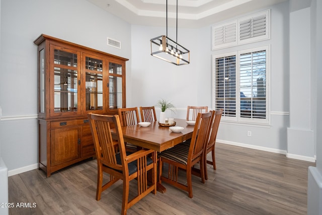 dining area featuring dark hardwood / wood-style flooring and a notable chandelier