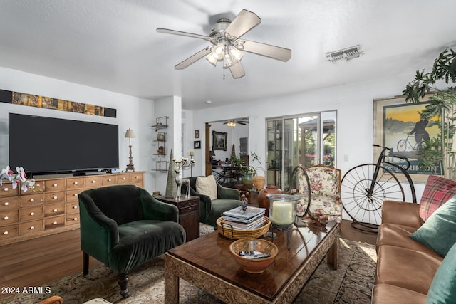 living room with hardwood / wood-style flooring and ceiling fan