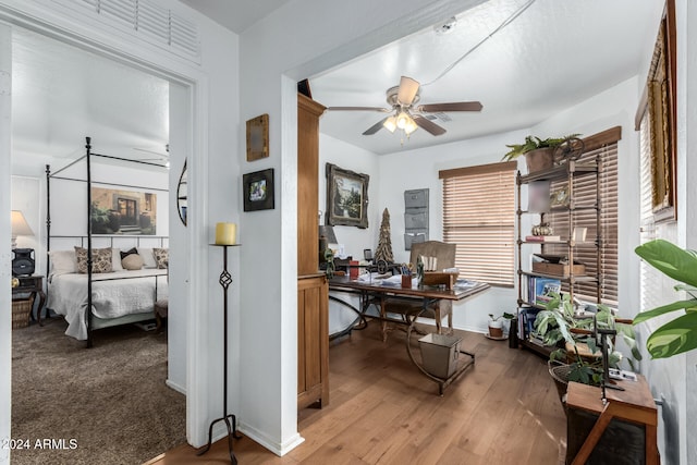 home office featuring hardwood / wood-style flooring and ceiling fan