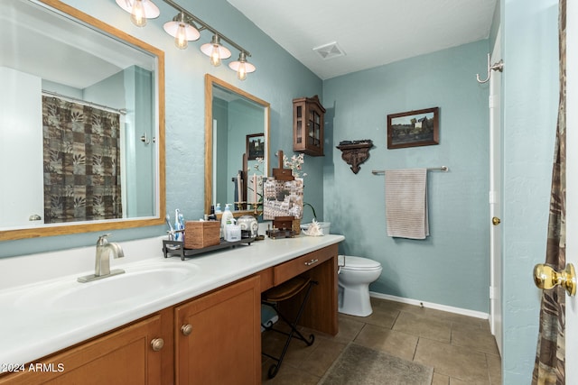 bathroom with vanity, toilet, and tile patterned flooring