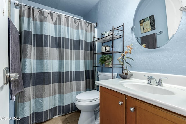 bathroom with vanity, toilet, tile patterned floors, and curtained shower