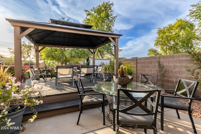 view of patio featuring a wooden deck and a gazebo