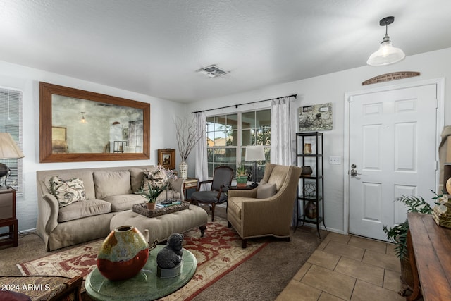 living room featuring carpet and a textured ceiling