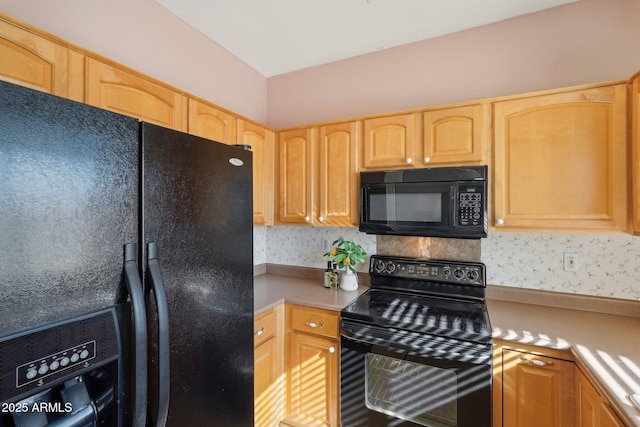 kitchen featuring light brown cabinetry, backsplash, and black appliances