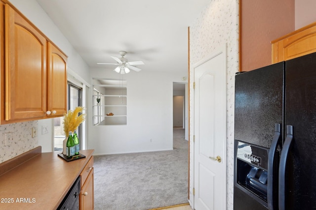 kitchen with dishwasher, light colored carpet, black fridge, and ceiling fan