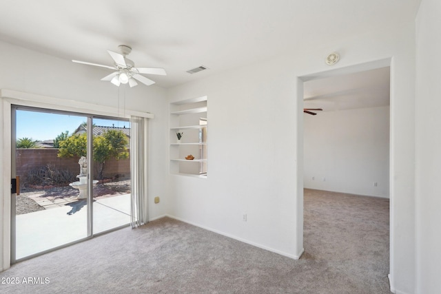 spare room with light colored carpet and ceiling fan