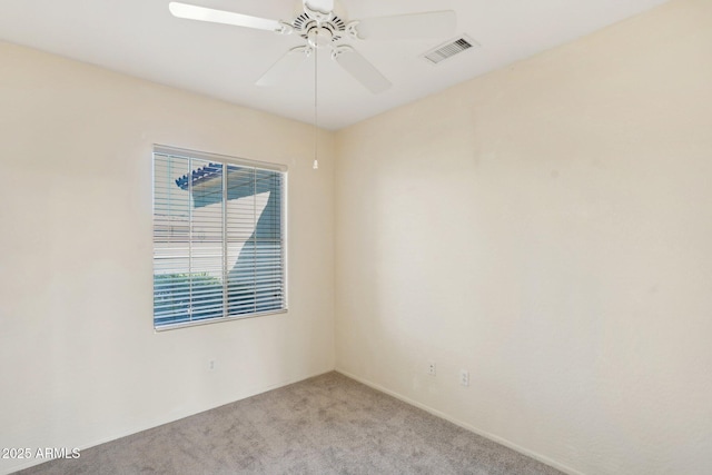 unfurnished room with ceiling fan and light colored carpet