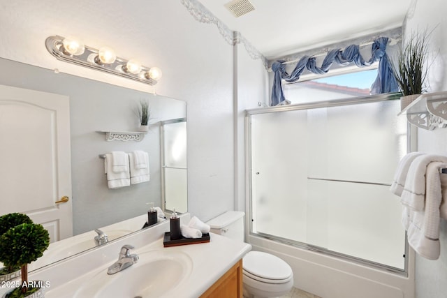 full bathroom with toilet, vanity, and combined bath / shower with glass door