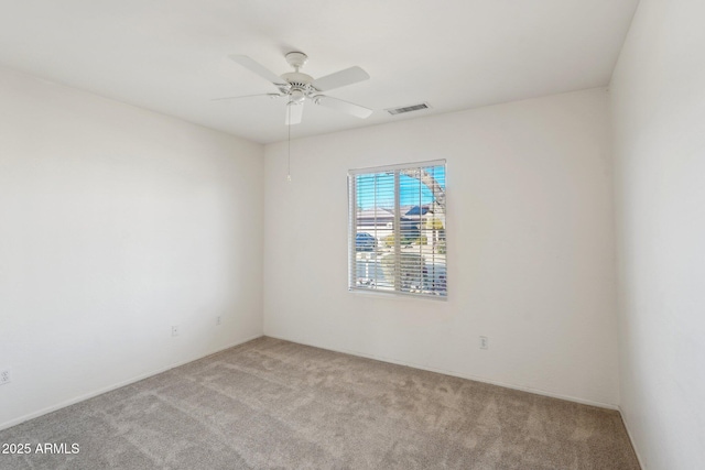 empty room featuring light carpet and ceiling fan