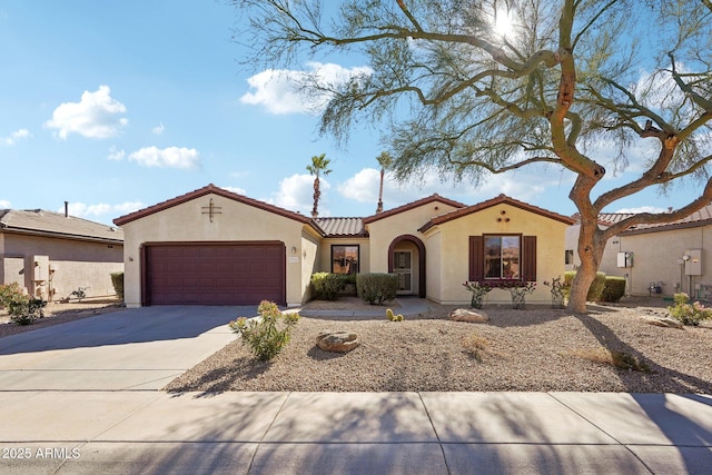 mediterranean / spanish-style home with a garage