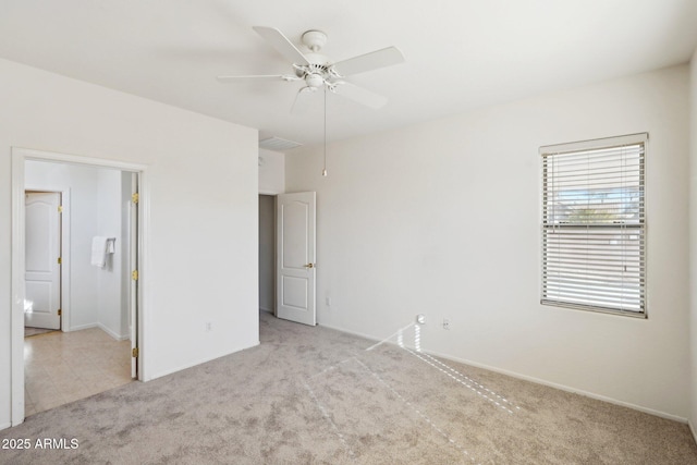 unfurnished room with ceiling fan and light carpet