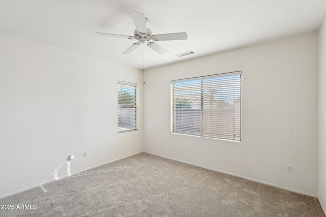 carpeted spare room with ceiling fan