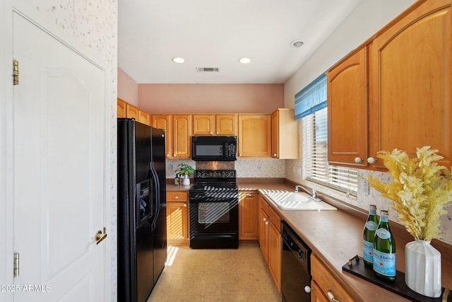 kitchen with black appliances and sink