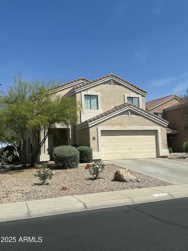 23284 W Pima St, Buckeye, AZ 85326 - view of front of house with a garage, a tile roof, driveway, and stucco siding