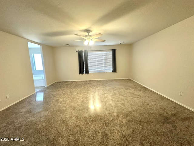 23284 W Pima St, Buckeye, AZ 85326 - unfurnished room with dark carpet, ceiling fan, and a textured ceiling