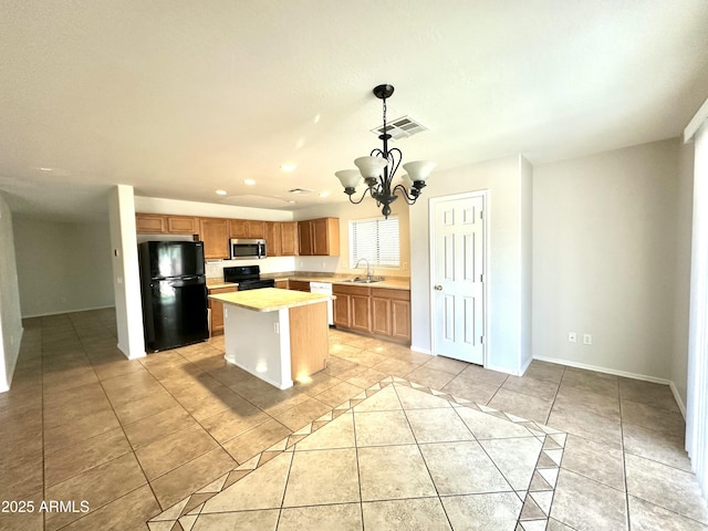 23284 W Pima St, Buckeye, AZ 85326 - kitchen featuring black appliances, light countertops, light tile patterned flooring, a chandelier, and a center island