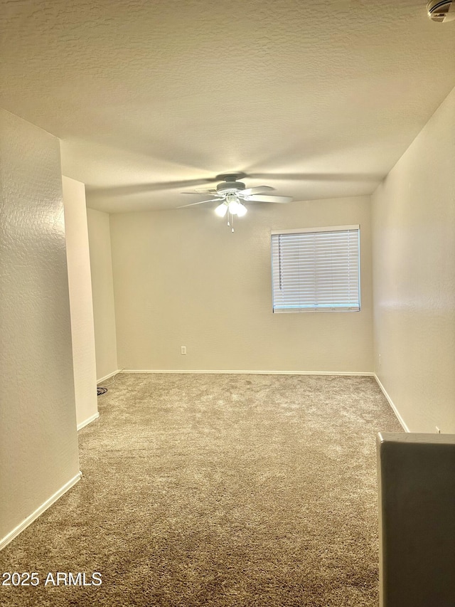 23284 W Pima St, Buckeye, AZ 85326 - carpeted empty room featuring a ceiling fan and baseboards