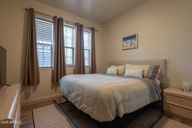 bedroom with wood finished floors and baseboards
