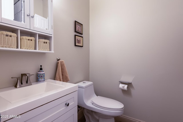 half bath featuring toilet and vanity