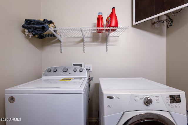 laundry room with separate washer and dryer and laundry area