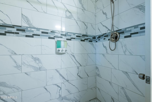 bathroom with tiled shower