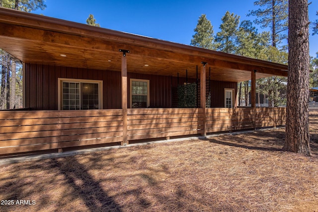 exterior space featuring board and batten siding, an exterior structure, and an outbuilding