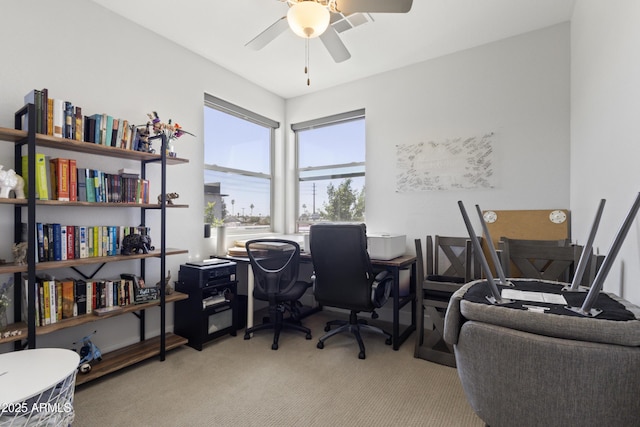 office with carpet and a ceiling fan