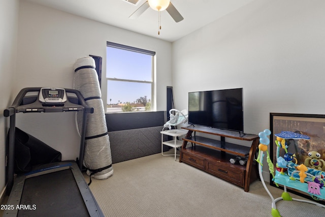 exercise room with carpet flooring and a ceiling fan