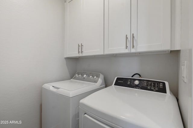 laundry area featuring cabinet space and separate washer and dryer