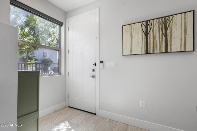 foyer entrance featuring baseboards