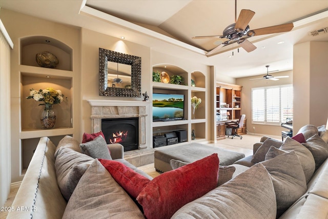 living room featuring built in features and a tiled fireplace